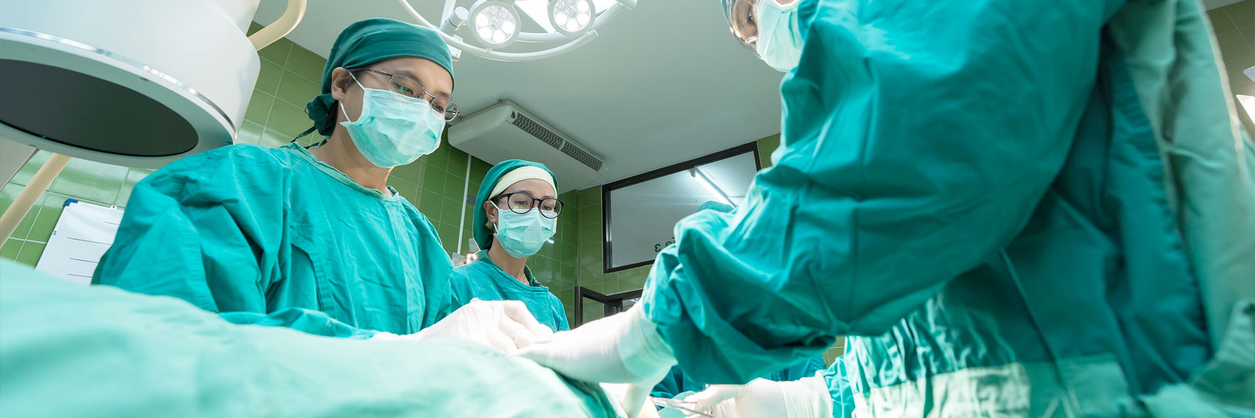 Group of surgeons operating on a patient.